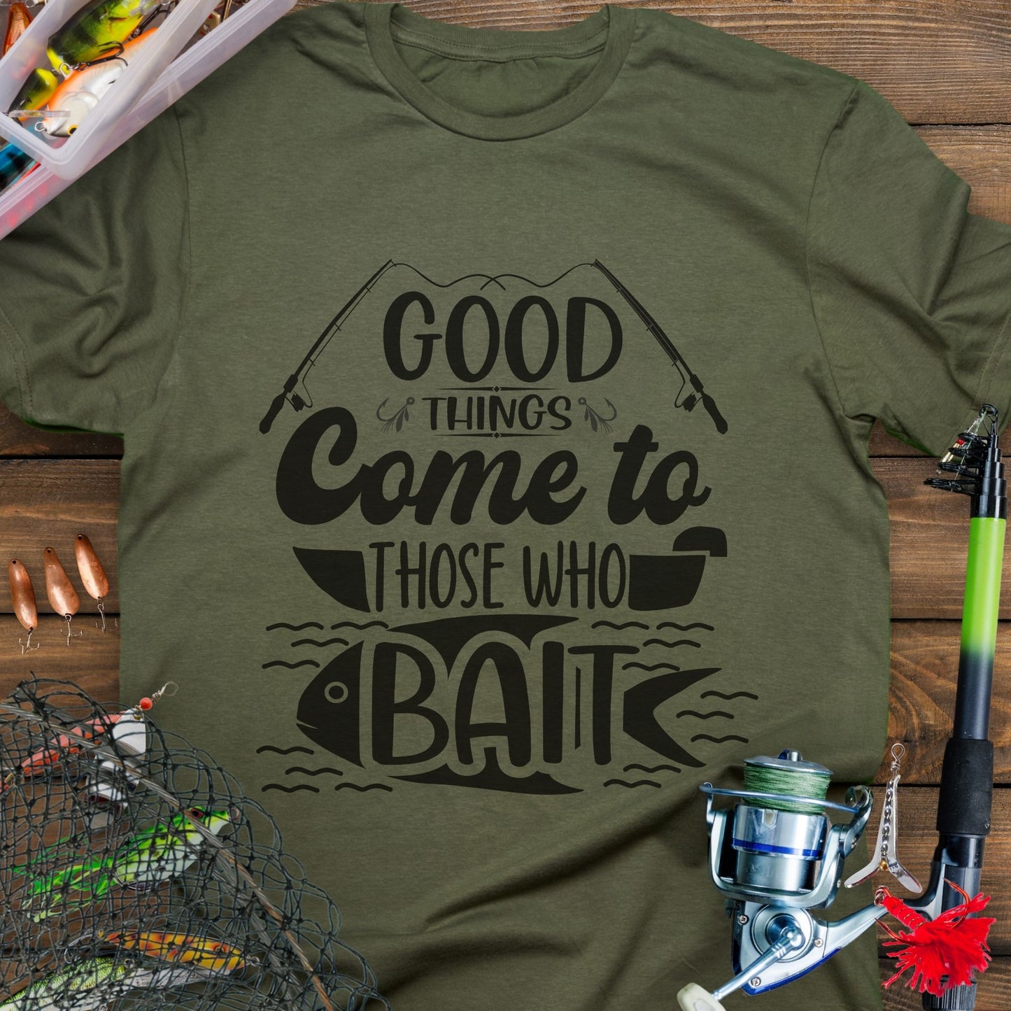 Military Green t-shirt with Two fishing poles and a fist that says Good Things Come to Those That Wait. Perfect for the angler in your life!