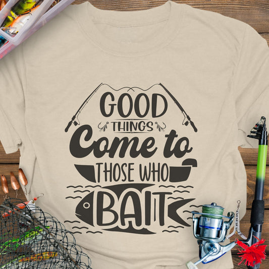 Natural t-shirt with Two fishing poles and a fist that says Good Things Come to Those That Wait. Perfect for the angler in your life!