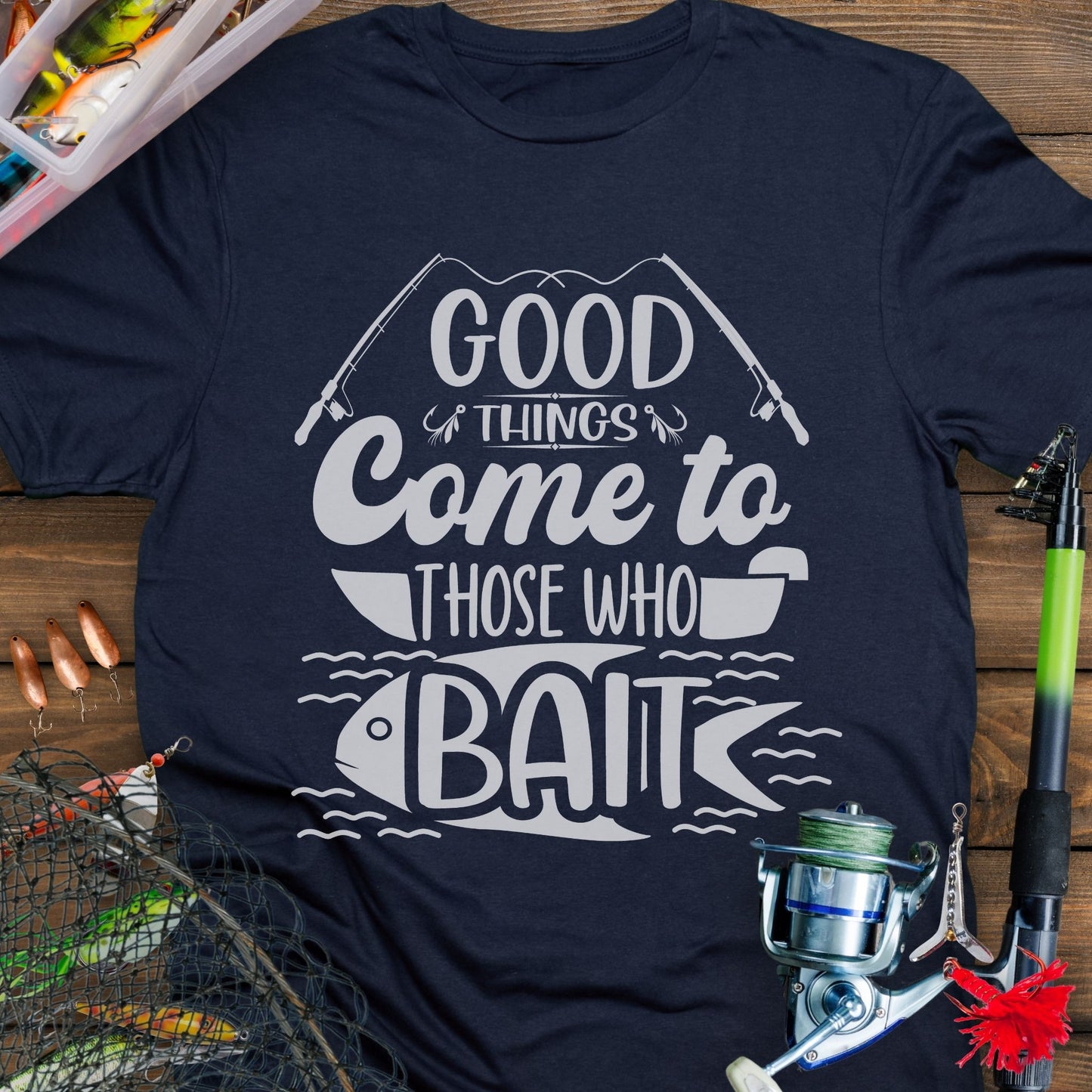 Navy t-shirt with Two fishing poles and a fist that says Good Things Come to Those That Wait. Perfect for the angler in your life!