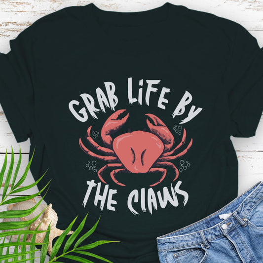 Black Unisex t-shirt with 'Grab Life by the Claws' crab graphic on front – coastal-themed summer apparel