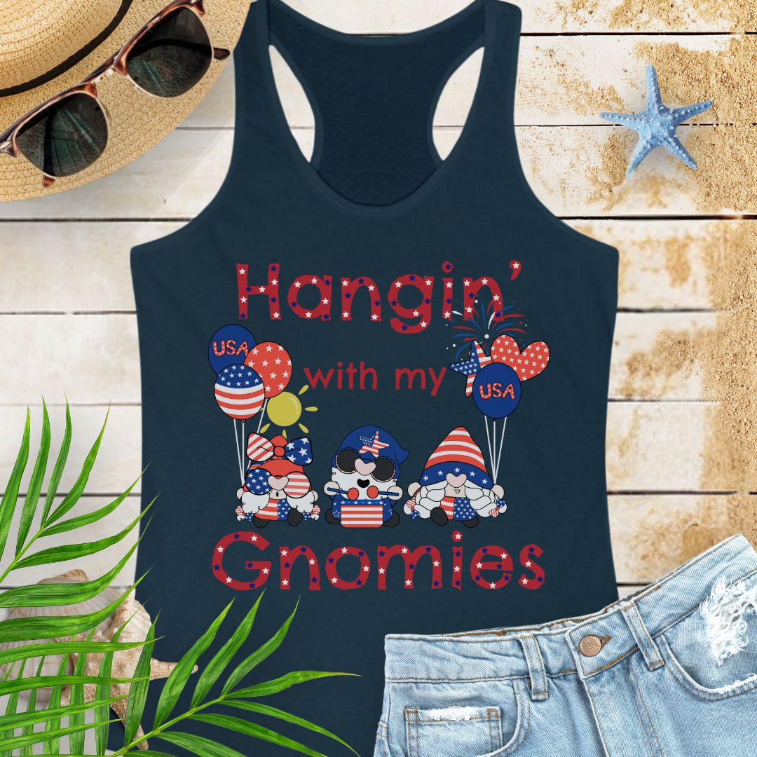 Navy women’s racerback tank top with patriotic gnomes holding American flag balloons, with fireworks and sunshine in the background.