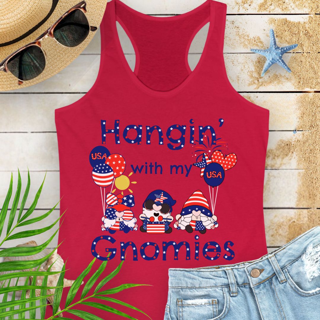 Red women’s racerback tank top with patriotic gnomes holding American flag balloons, with fireworks and sunshine in the background.