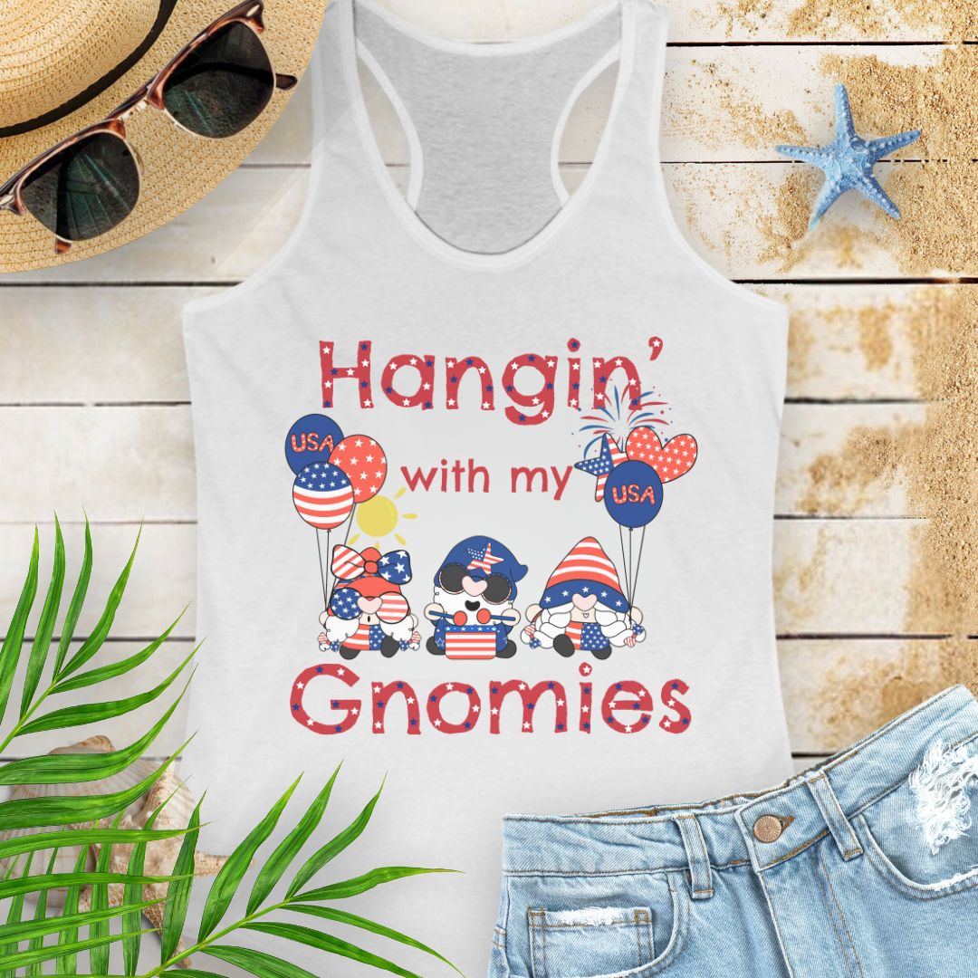 White women’s racerback tank top with patriotic gnomes holding American flag balloons, with fireworks and sunshine in the background.