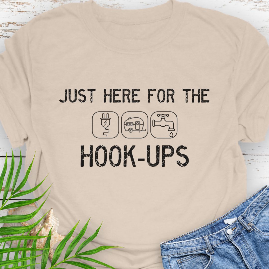Natural funny camping t-shirt with ‘Here for the Hook-ups’ text and RV utility icons.
