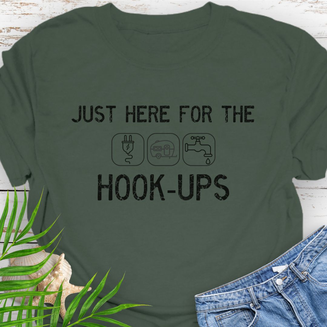 Military Green funny camping t-shirt with ‘Here for the Hook-ups’ text and RV utility icons.