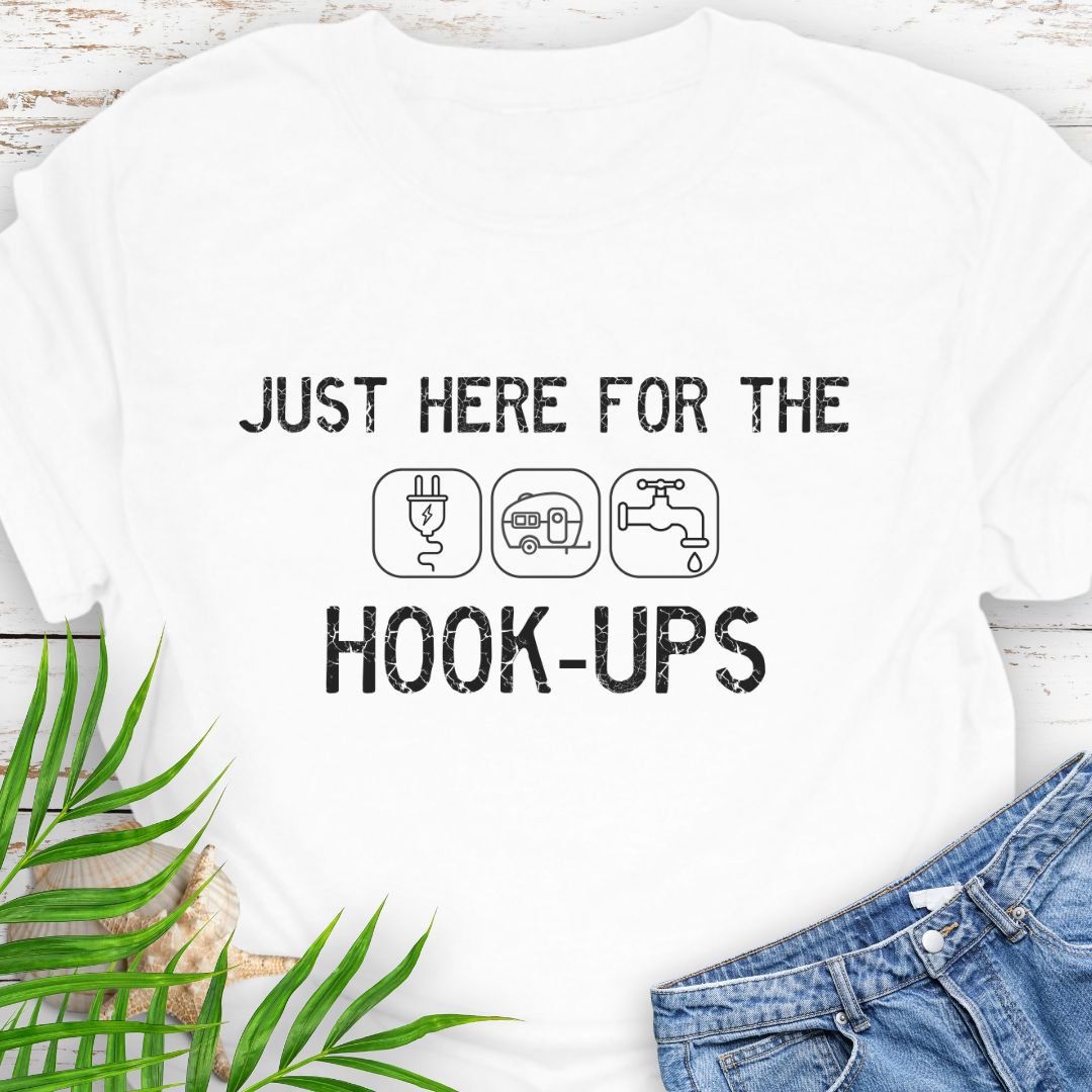 White funny camping t-shirt with ‘Here for the Hook-ups’ text and RV utility icons.