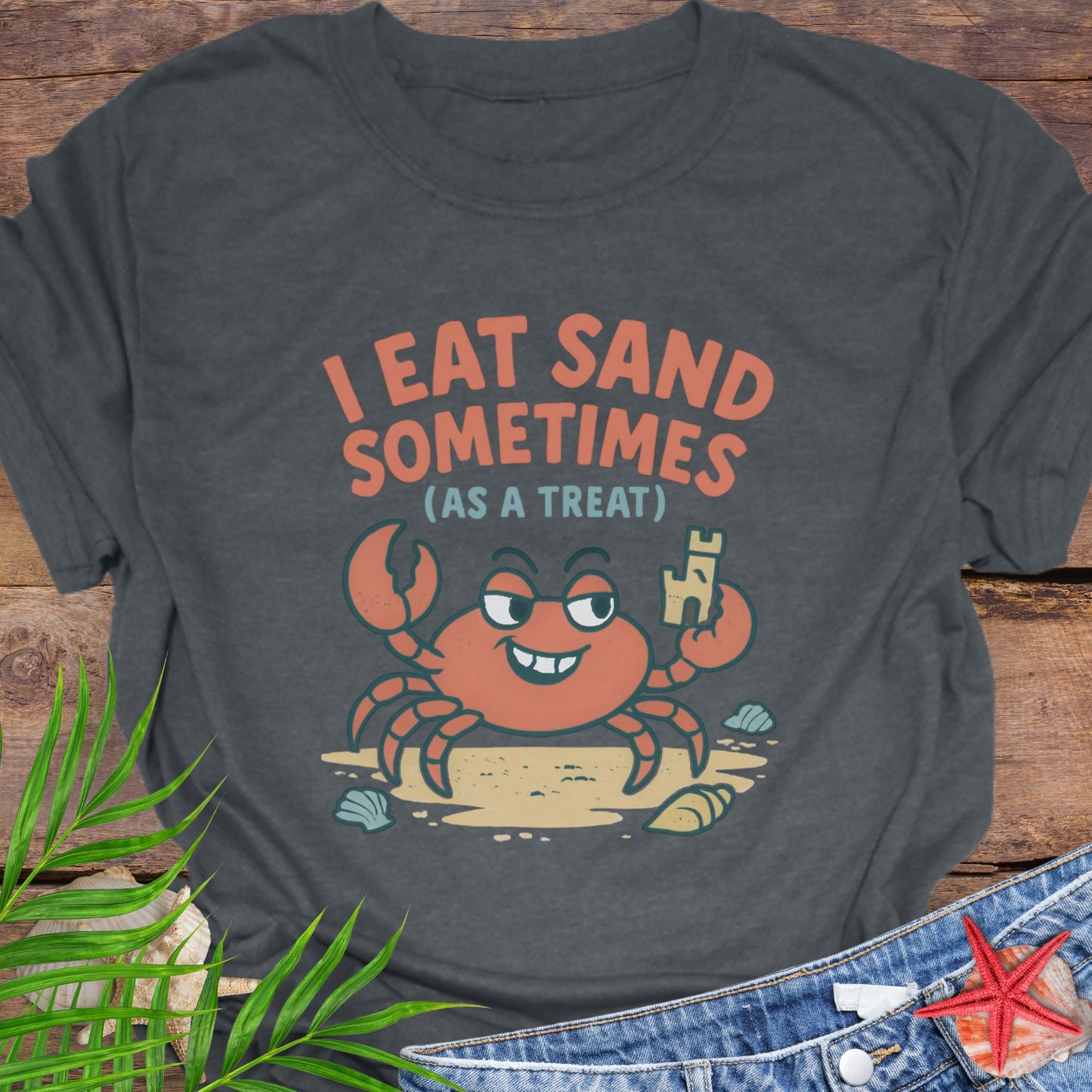 Gray I Eat Sand Sometimes as a Treat shirt featuring crab holding sandcastle.