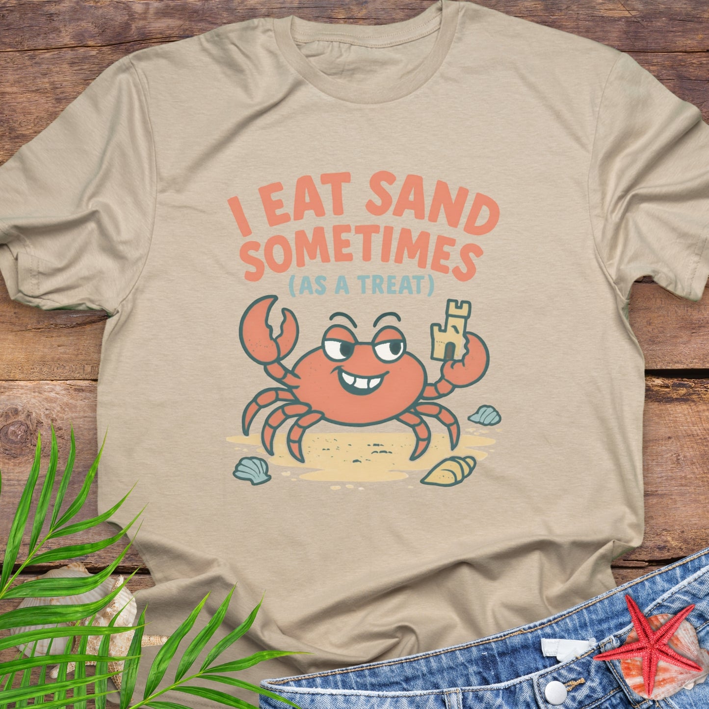 Beige I Eat Sand Sometimes as a Treat shirt featuring crab holding sandcastle.