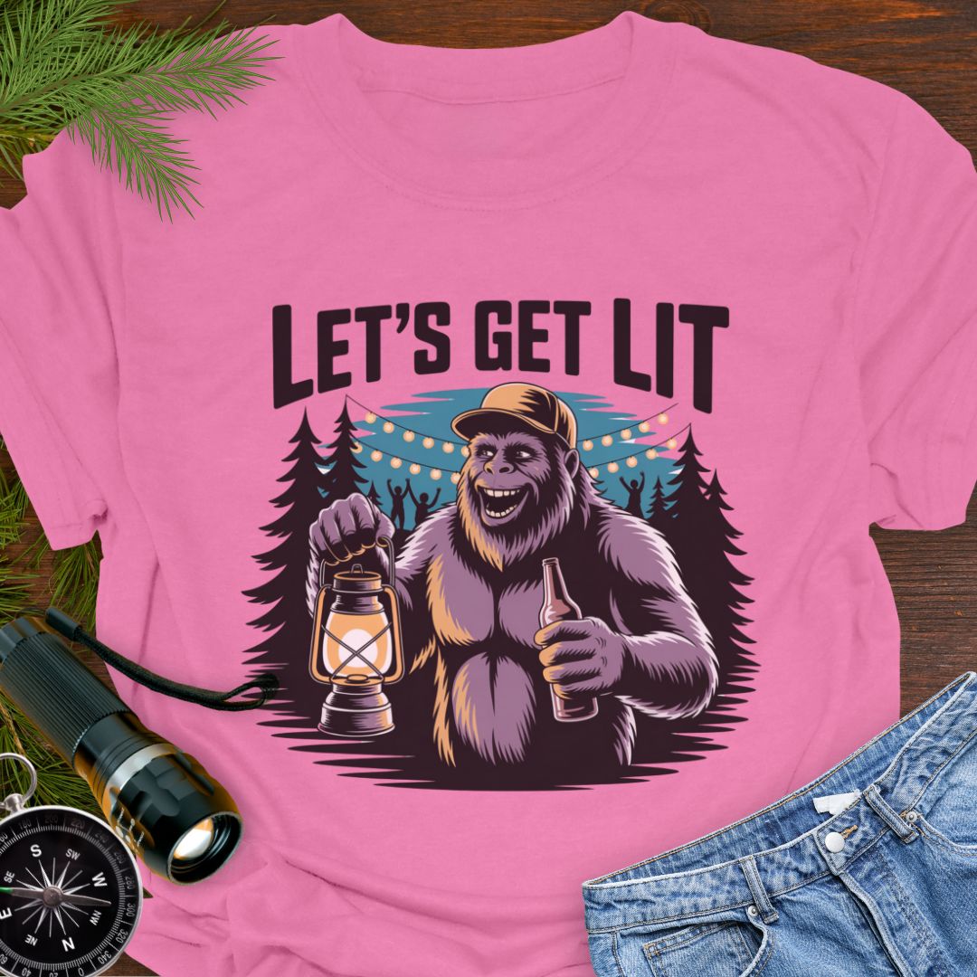 Azalea "Let's Get Lit" Sasquatch T-Shirt featuring a sasquatch wearing a baseball hat holding a camping lantern and a beer in a party scene in the woods.