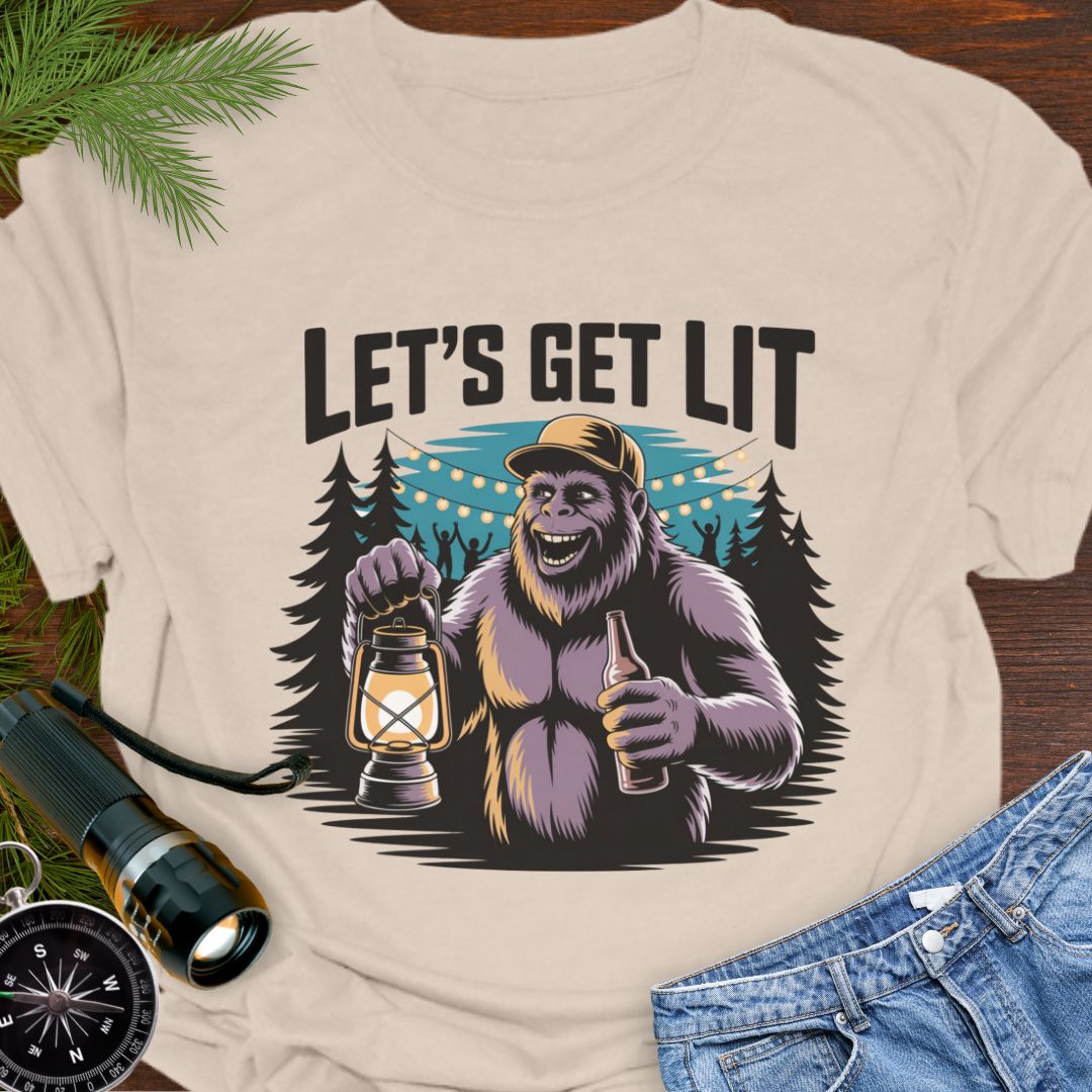 Natural "Let's Get Lit" Sasquatch T-Shirt featuring a sasquatch wearing a baseball hat holding a camping lantern and a beer in a party scene in the woods.