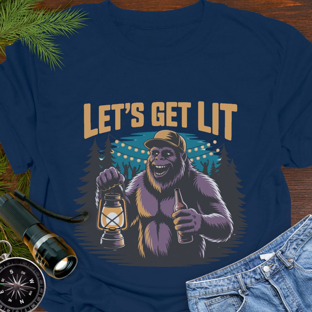 Navy "Let's Get Lit" Sasquatch T-Shirt featuring a sasquatch wearing a baseball hat holding a camping lantern and a beer in a party scene in the woods.