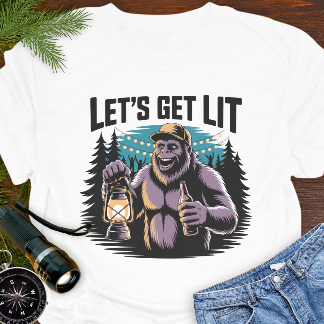 White "Let's Get Lit" Sasquatch T-Shirt featuring a sasquatch wearing a baseball hat holding a camping lantern and a beer in a party scene in the woods.