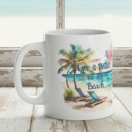 Two mugs with beach-themed designs on a surface with a blurred background of water and sky.