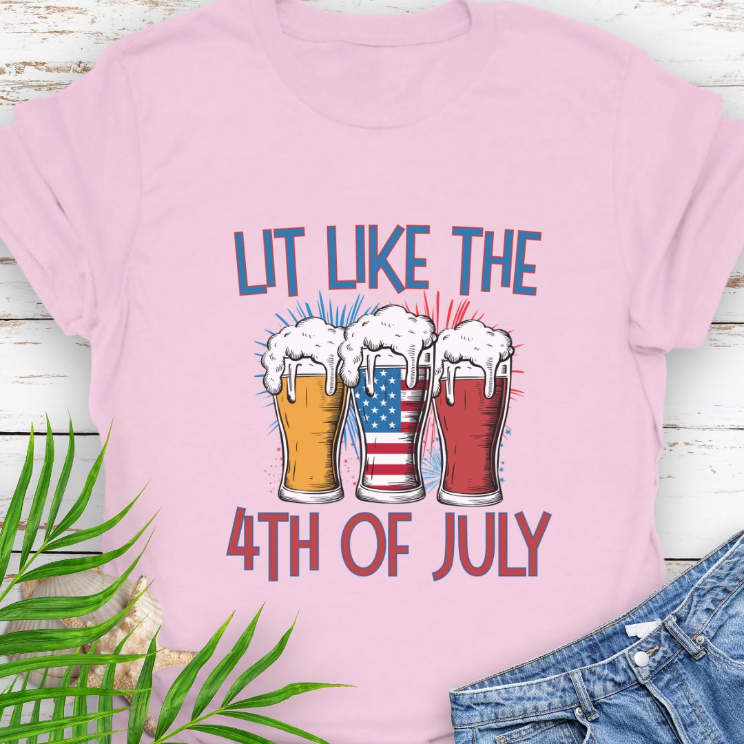 Light Pink T-shirt graphic showing three pint glasses of beer with one filled by the American flag and the phrase "Lit Like the 4th of July" in bold lettering.