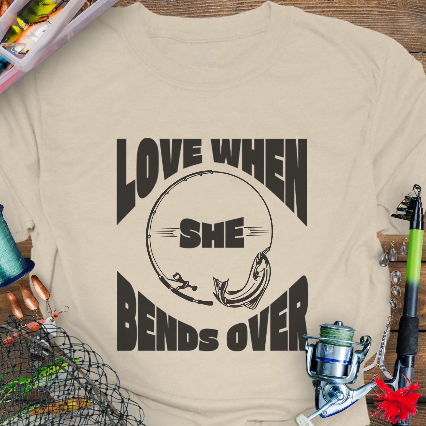 Natural T-shirt with a fishing pole bending over and the phrase “Love When She Bends Over” – humorous fishing design for anglers.