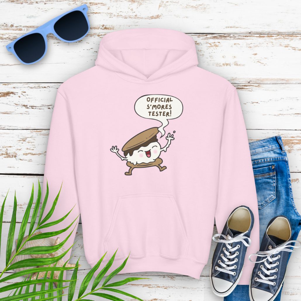 Pink Youth hoodie with "Official S’mores Tester" text in a speech bubble with cartoon s'more – fun camping-themed sweatshirt for kid.