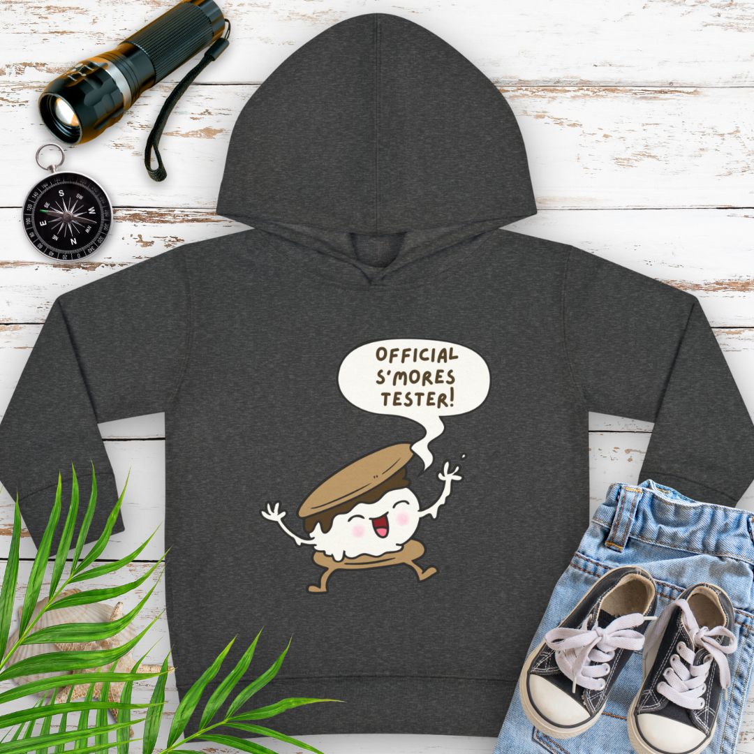 Vintage smoke cozy toddler hoodie with “Official S’mores Tester” speech bubble and a cartoon s'more – cute outdoor-themed sweatshirt for little campers.