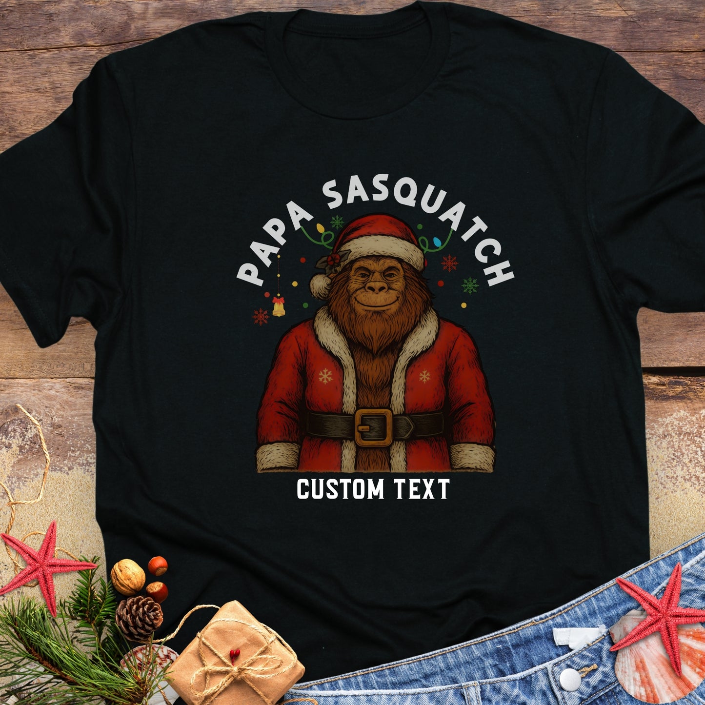 Black t-shirt with a graphic of a Sasquatch in a Santa outfit with custom text.