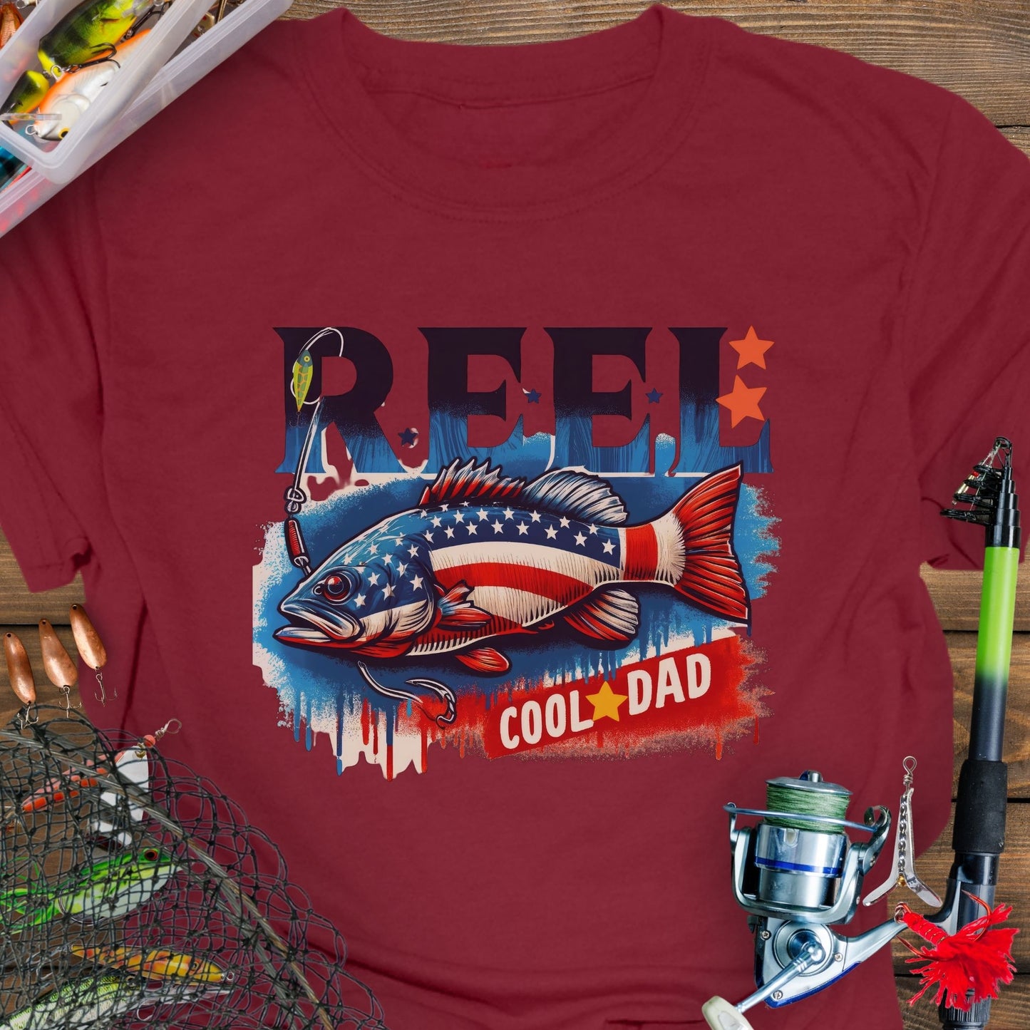 Cardinal Red patriotic fishing T-shirt with red, white, and blue design and the phrase “Reel Cool Dad”.