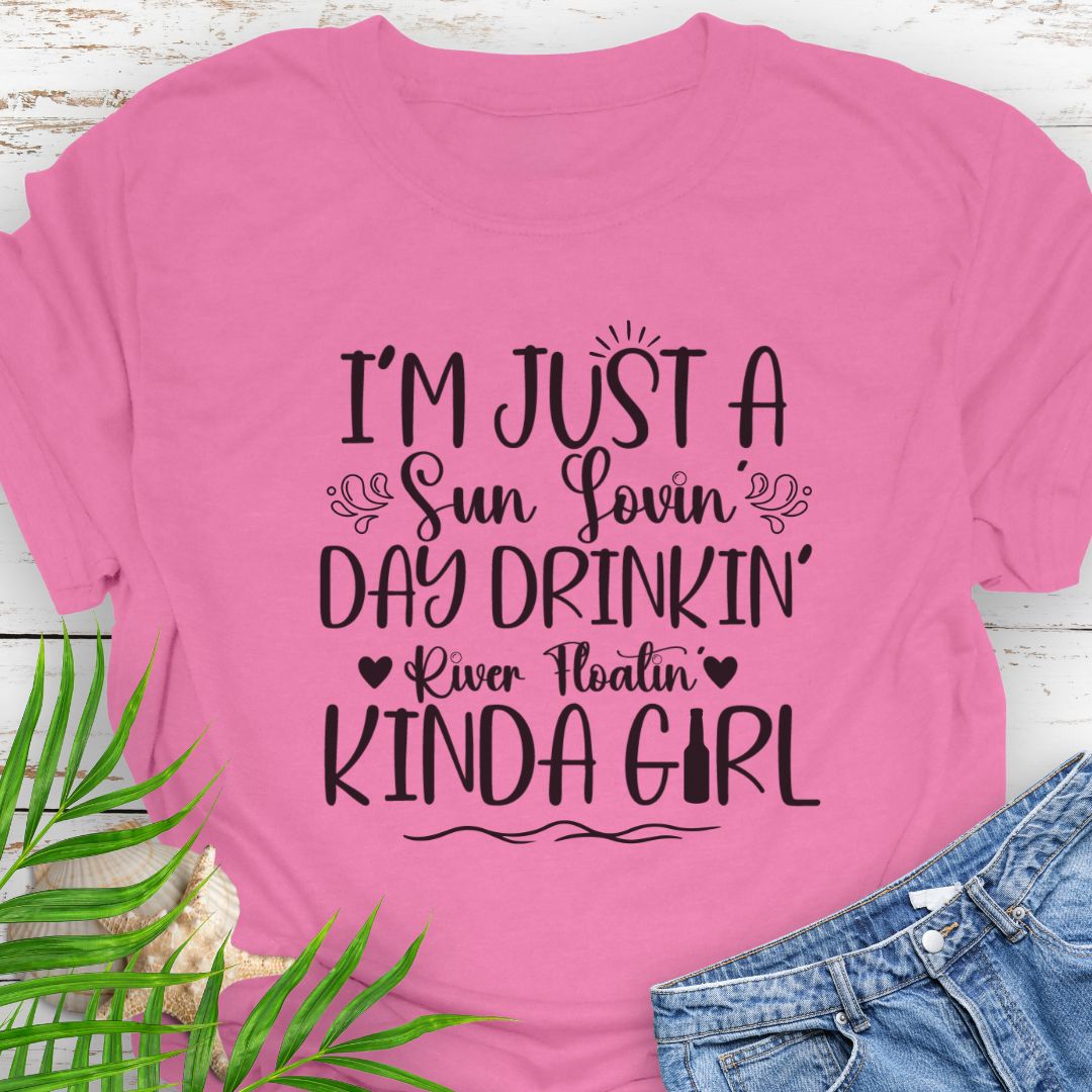 Azalea Unisex t-shirt with the phrase "Sun-loving, Day-drinking, River-floating Kind of Girl" printed on the front with embellishments, featuring a relaxed fit and soft cotton fabric.