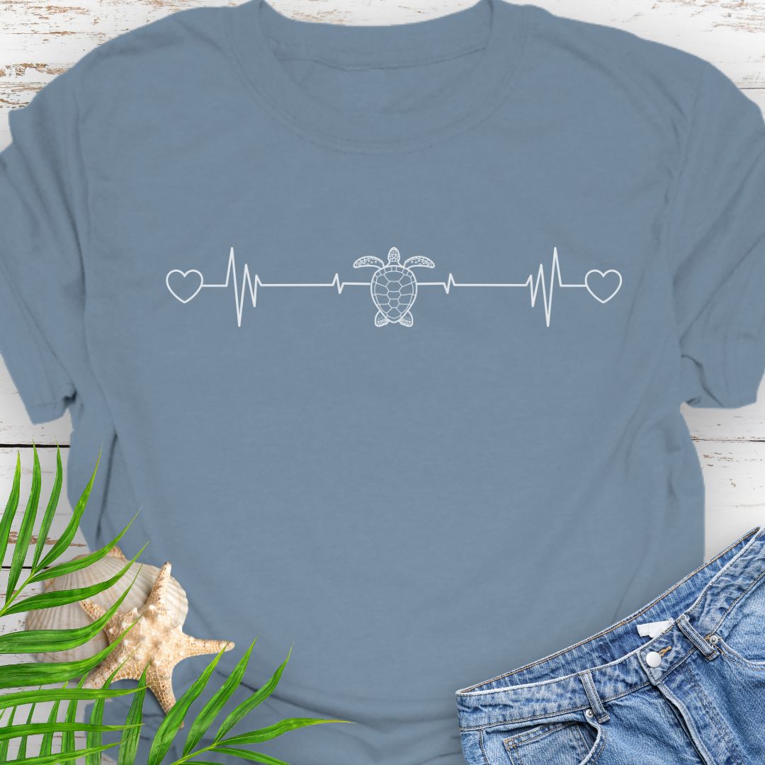 Stone Blue T-shirt with ocean heartbeat design with sea turtle in center symbolizing love for sea turtles.