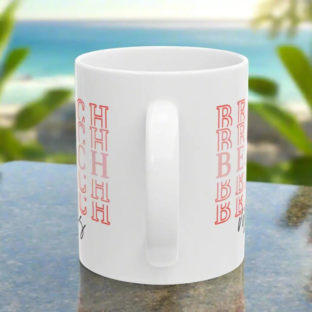 side view of white 11oz mug showing beach vibes on both sides