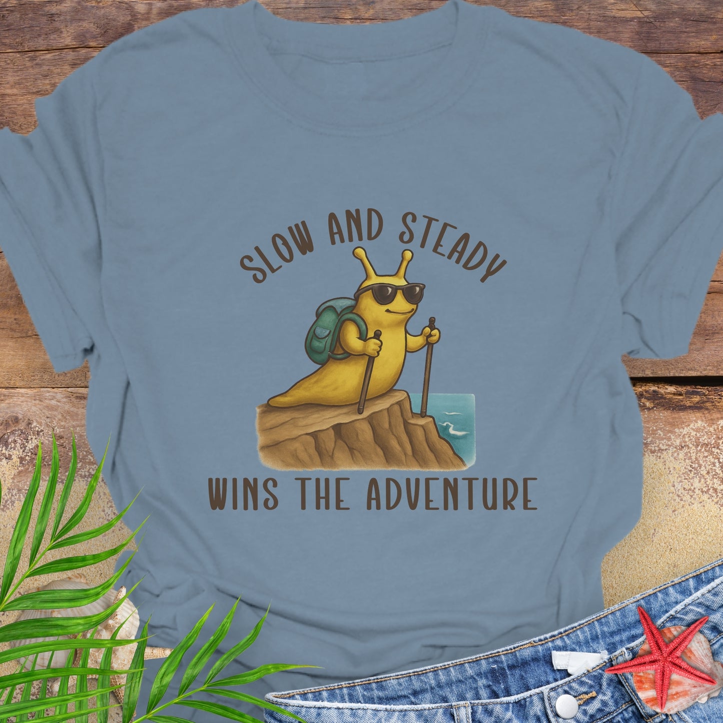 Blue t-shirt with a snail graphic and text 'Slow and Steady Wins the Adventure'.