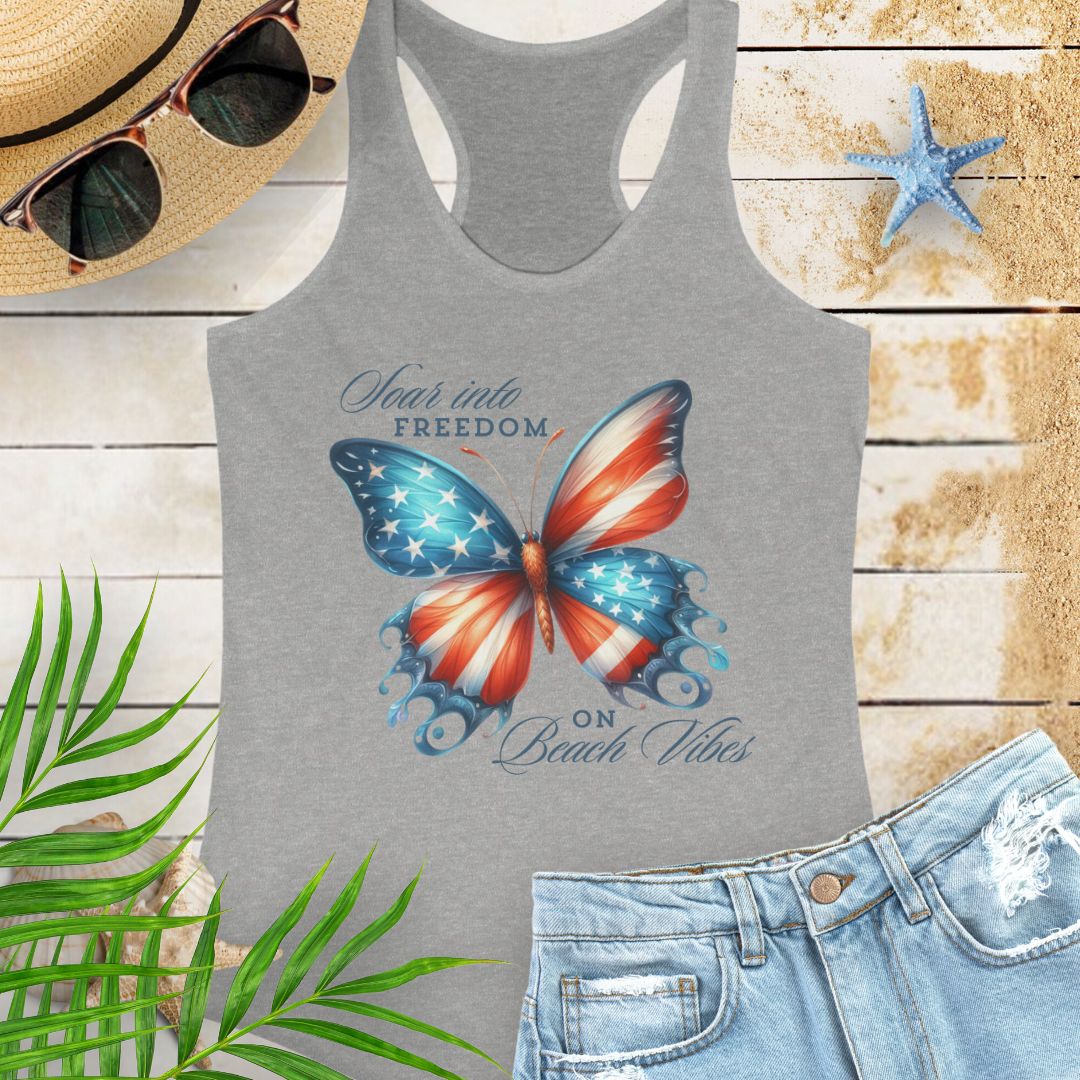 Gray patriotic women’s tank top with a American flag butterfly design and “Soaring into Freedom” slogan, featuring a scooped neckline and tear-away label.