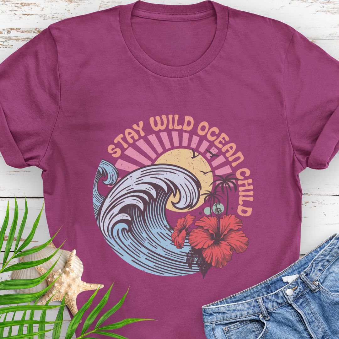 Antique Heliconia circular beach design with ocean wave, sun, and hibiscus flower and the phrase “Stay Wild Ocean Child”.