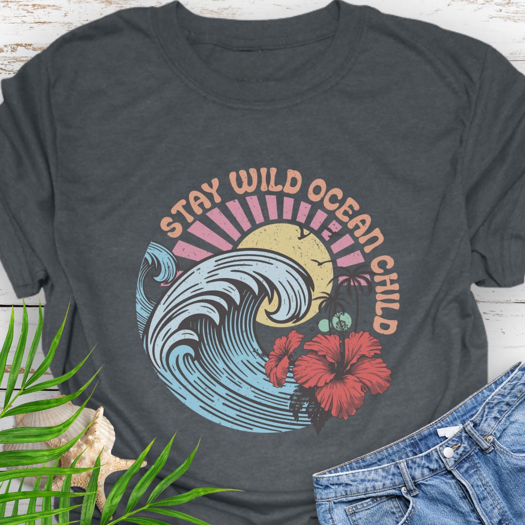 Dark Heather  circular beach design with ocean wave, sun, and hibiscus flower and the phrase “Stay Wild Ocean Child”.