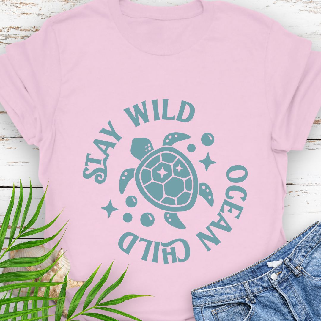Pink Stay Wild Ocean Child Sea Turtle T-Shirt featuring a sea turtle with phrase around the turtle - a beachy, free-spirited vibe for sea lovers.