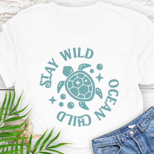 White Stay Wild Ocean Child Sea Turtle T-Shirt featuring a sea turtle with phrase around the turtle - a beachy, free-spirited vibe for sea lovers.