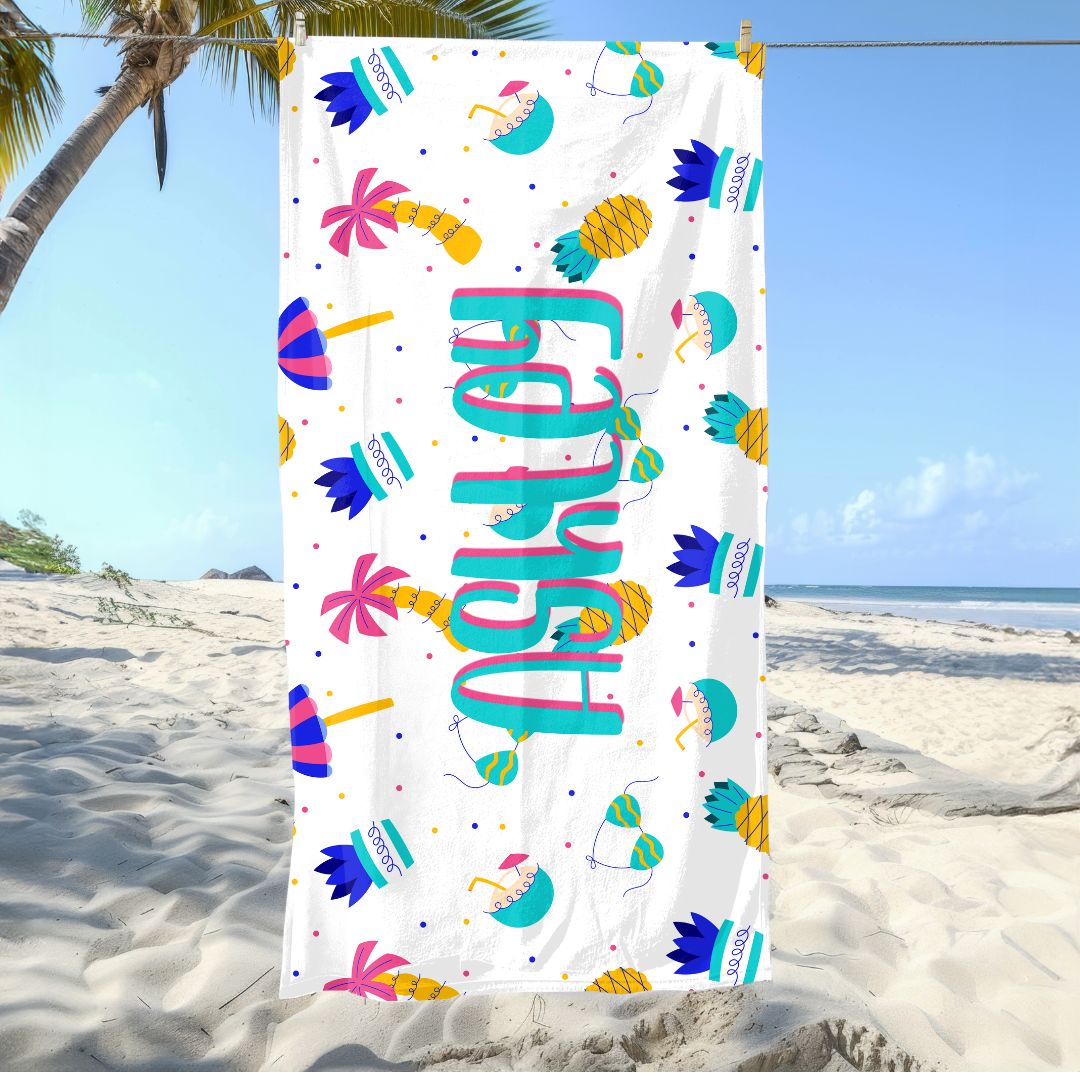 Colorful beach towel with pineapples, umbrellas, bikini, plants, palm trees, and personalized name.