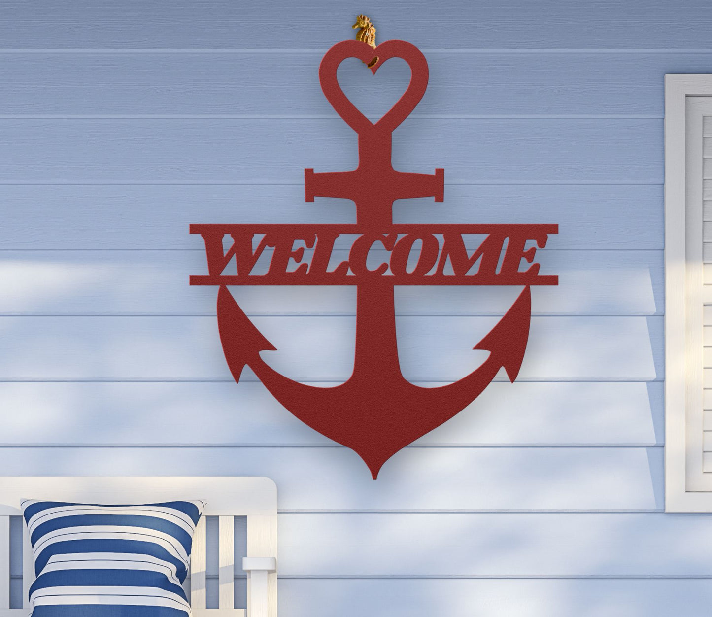 Red metal wall art shaped like an anchor with a heart at the top and the word “Welcome” cut out in the center; made of powder-coated steel.