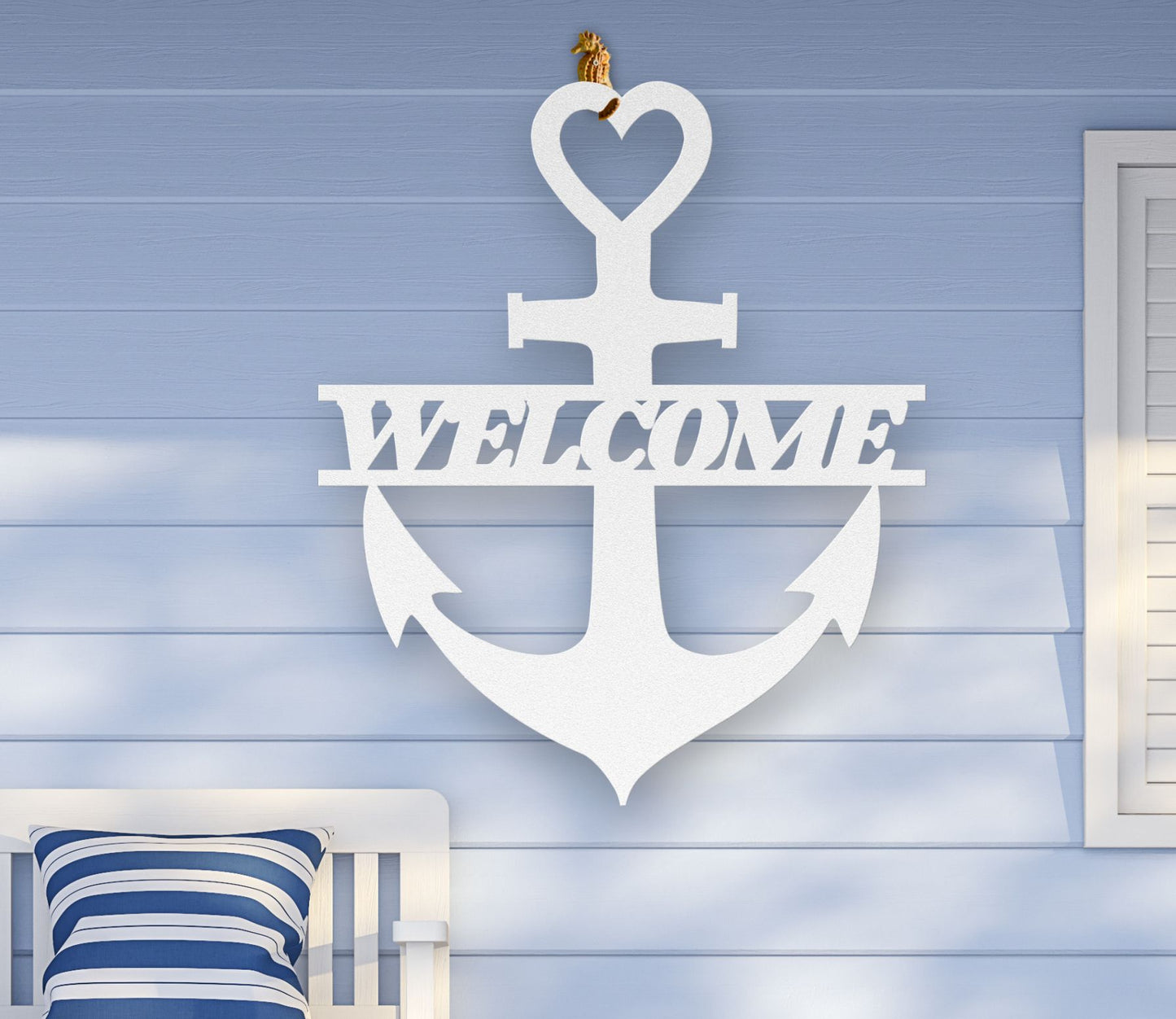 White metal wall art shaped like an anchor with a heart at the top and the word “Welcome” cut out in the center; made of powder-coated steel.