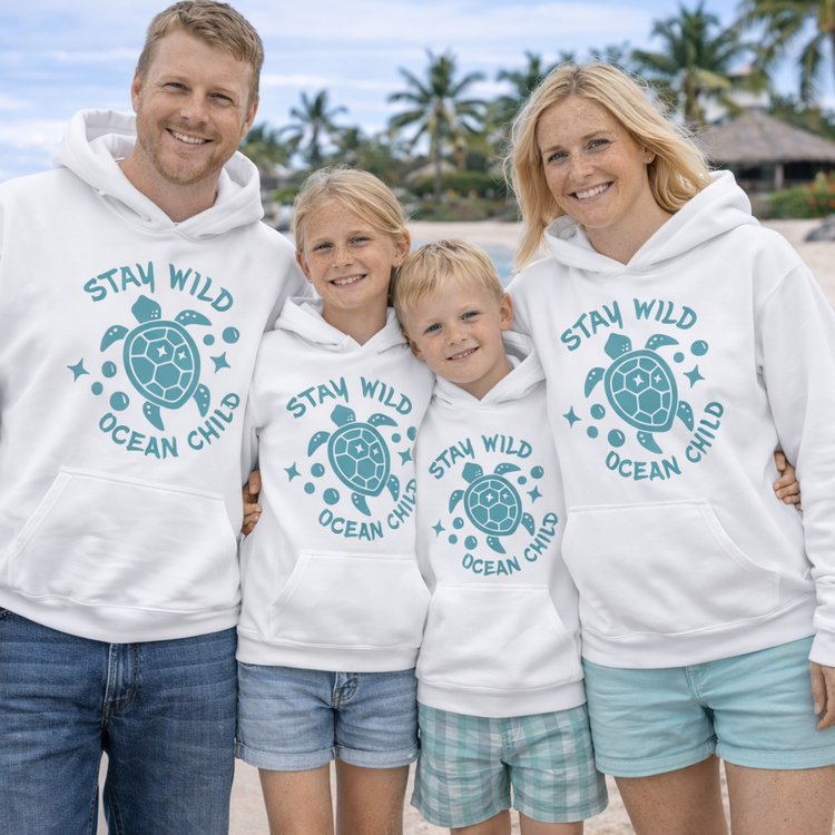 A family wearing hoodies with a sea turtle with text Stay Wild Ocean Child.