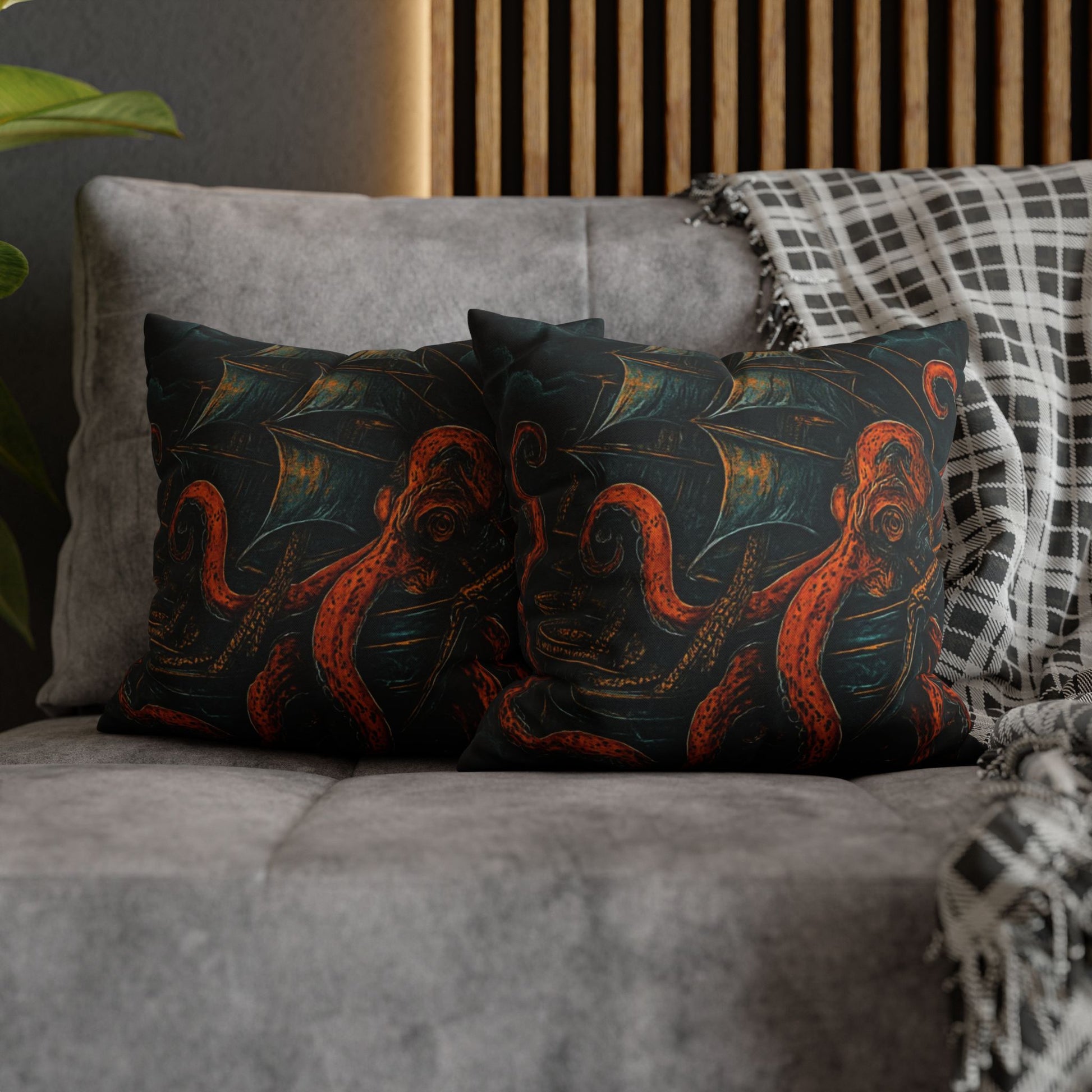 14" x 14" Decorative pillows with octopus design on a gray sofa.
