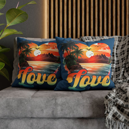 Two decorative 20" x 20" blue pillows with a sunset heart design and 'love' text on a gray couch.