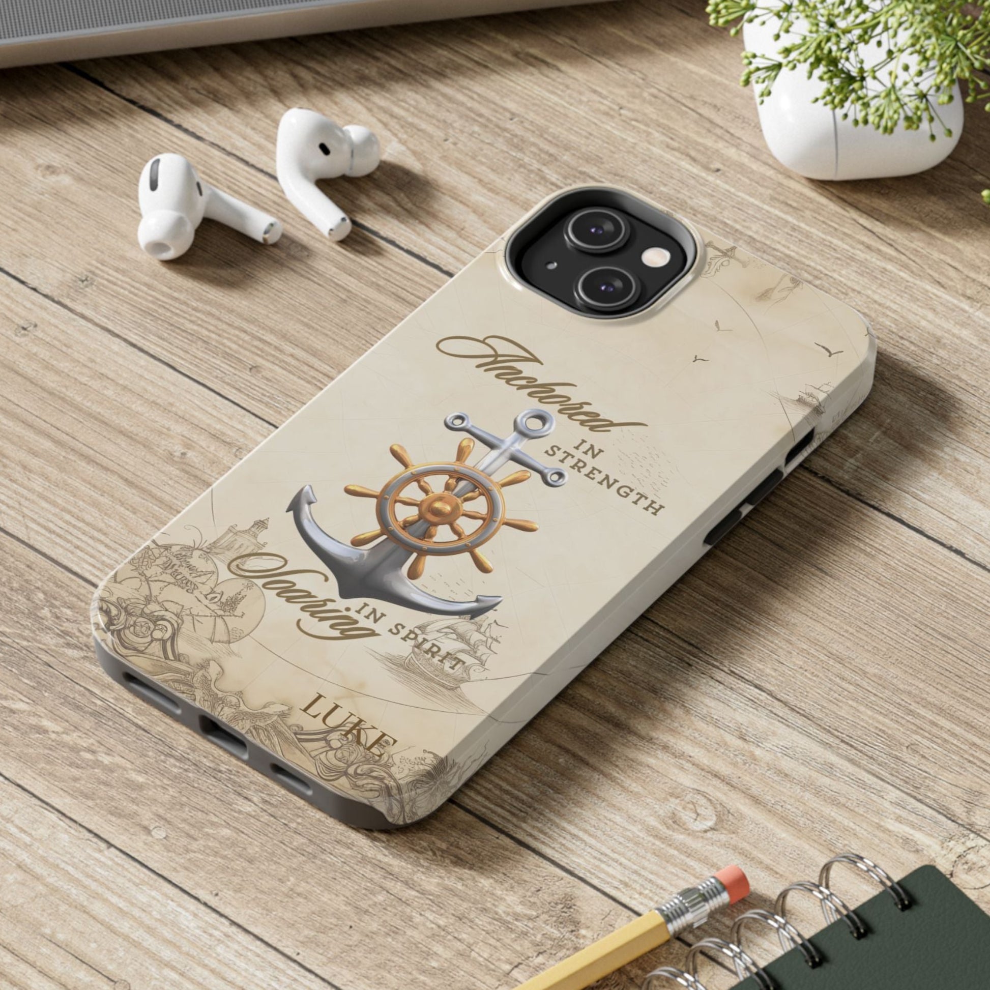 Phone case with anchor and ship wheel design with text 'Anchored in Strength soaring in Spirit' that can be personalized.