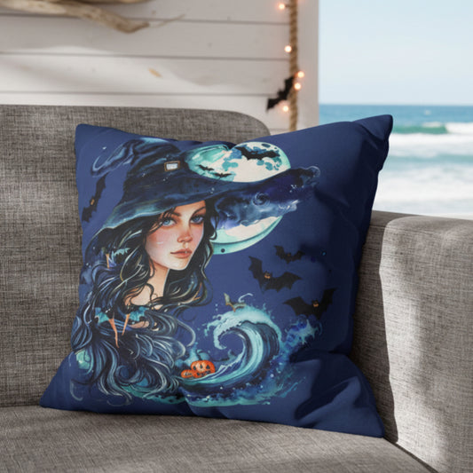 Decorative pillow case with a witch design on a gray couch