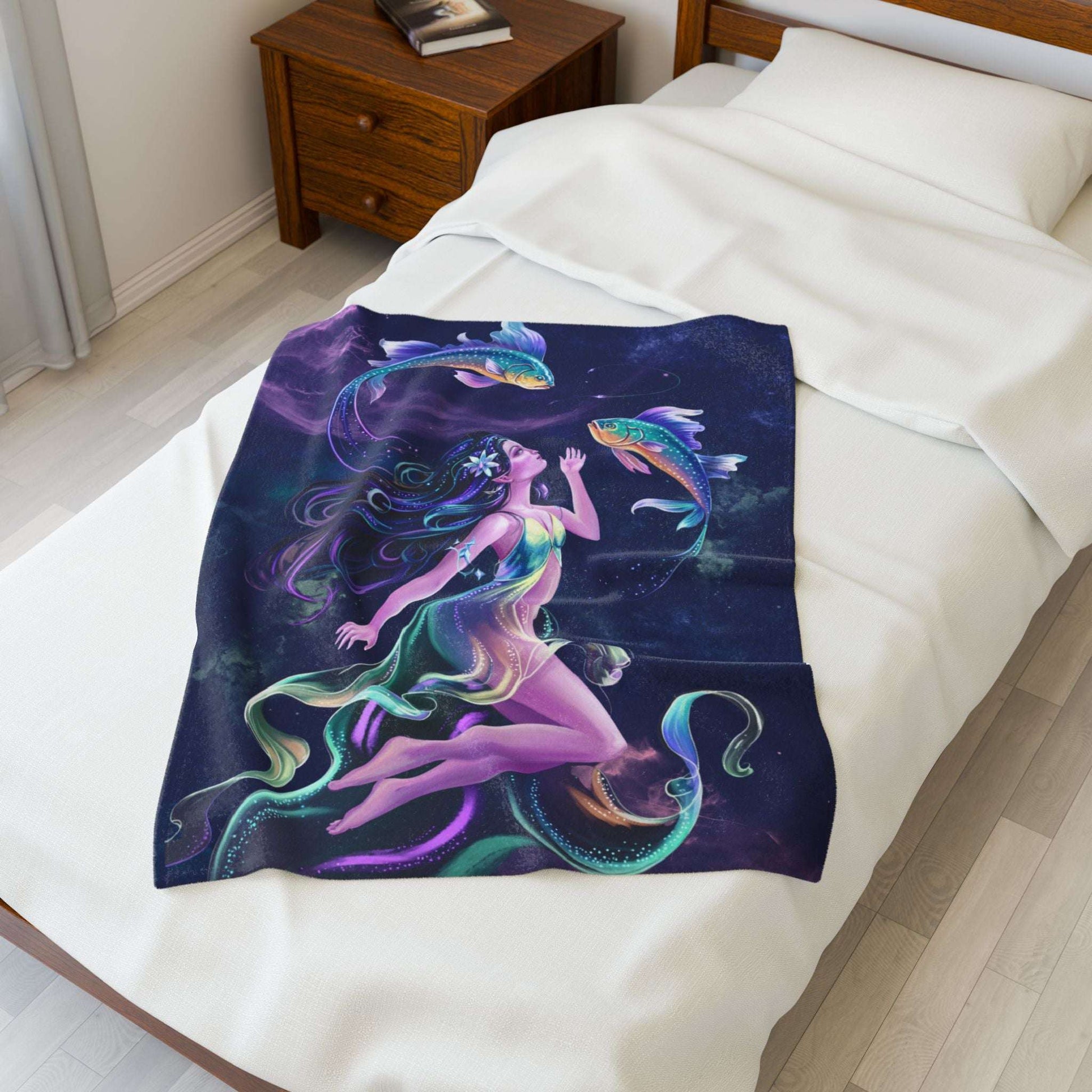 Colorful mermaid and fish design blanket on a bed