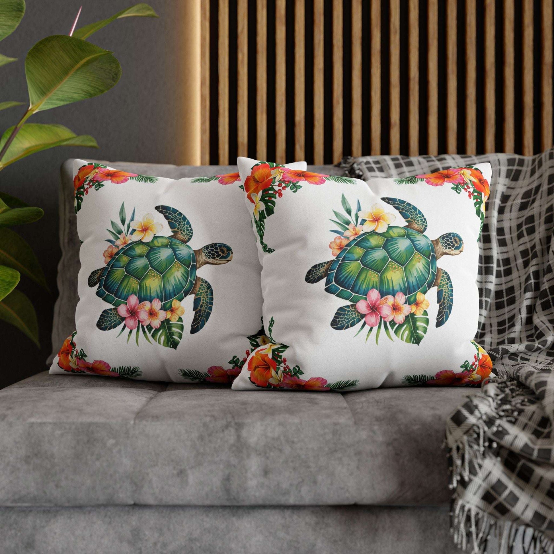 Two 20" x 20" white pillowcase with hibiscus flowers and a sea turtle design.