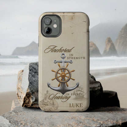 Tough personalized phone case featuring an anchor and ship wheel on an old style map design titled “Anchored Spirit Soaring Strength” with glossy finish, shown on a smartphone at the beach.
