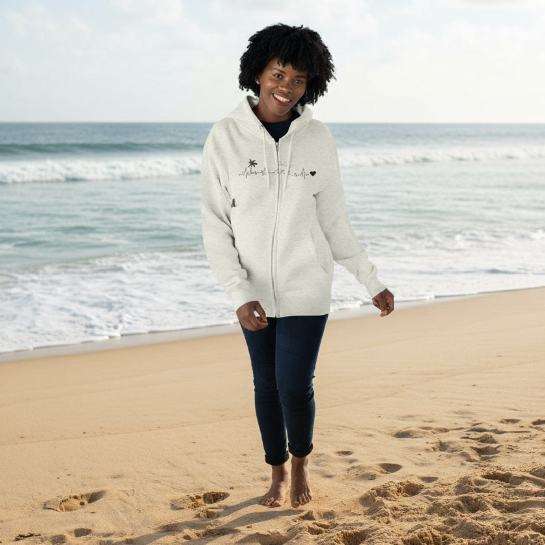 Person wearing a light gray hoodie with text and graphics on a light blue background