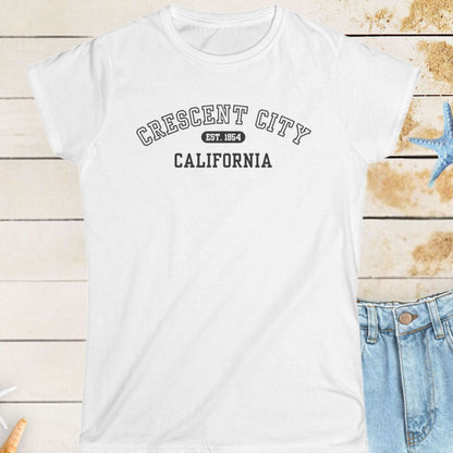 White t-shirt with 'Crescent City, California' text on a wooden surface with starfish.