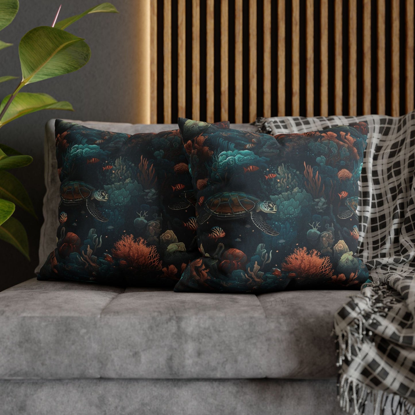 20" x 20" two decorative pillows with underwater scene with sea turtles on a gray couch.