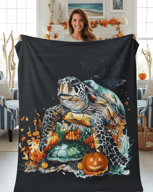 Person holding a blanket with a sea turtle and pumpkin design in a living room.