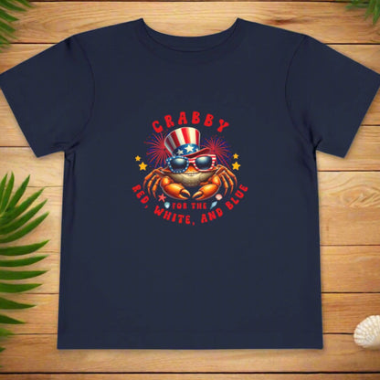 Navy blue t-shirt with a crab graphic and text on a wooden surface
