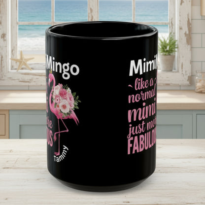 Black mug with pink flamingo design and text on a white background