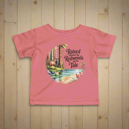 Pink t-shirt with nature-themed graphic and text on a white background